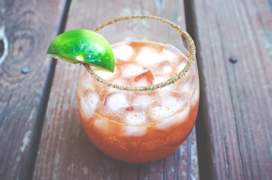 A michelada with a chili-salt rim, a classic pairing for salty chicharrones